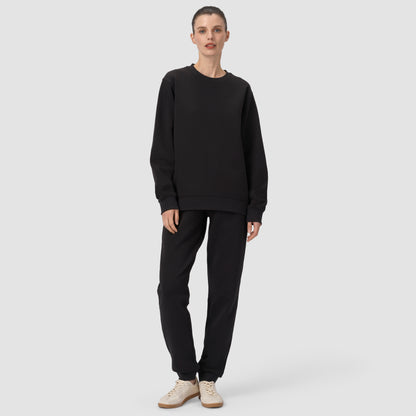 Person wearing a black outfit on a white background