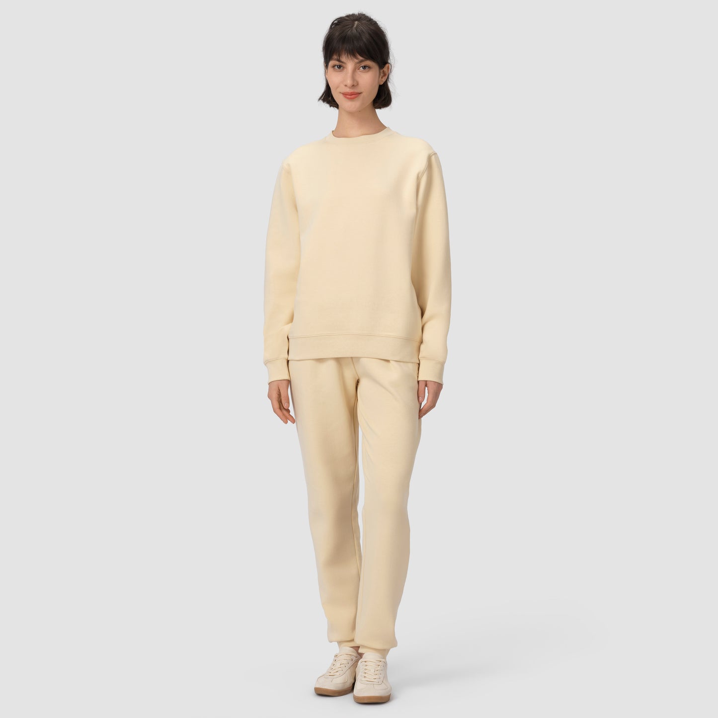 Full feet model wearing cream loungewear set in plain background