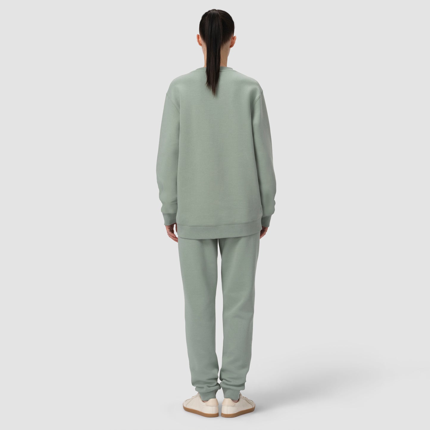 Back of model wearing green sage loungewear matching set