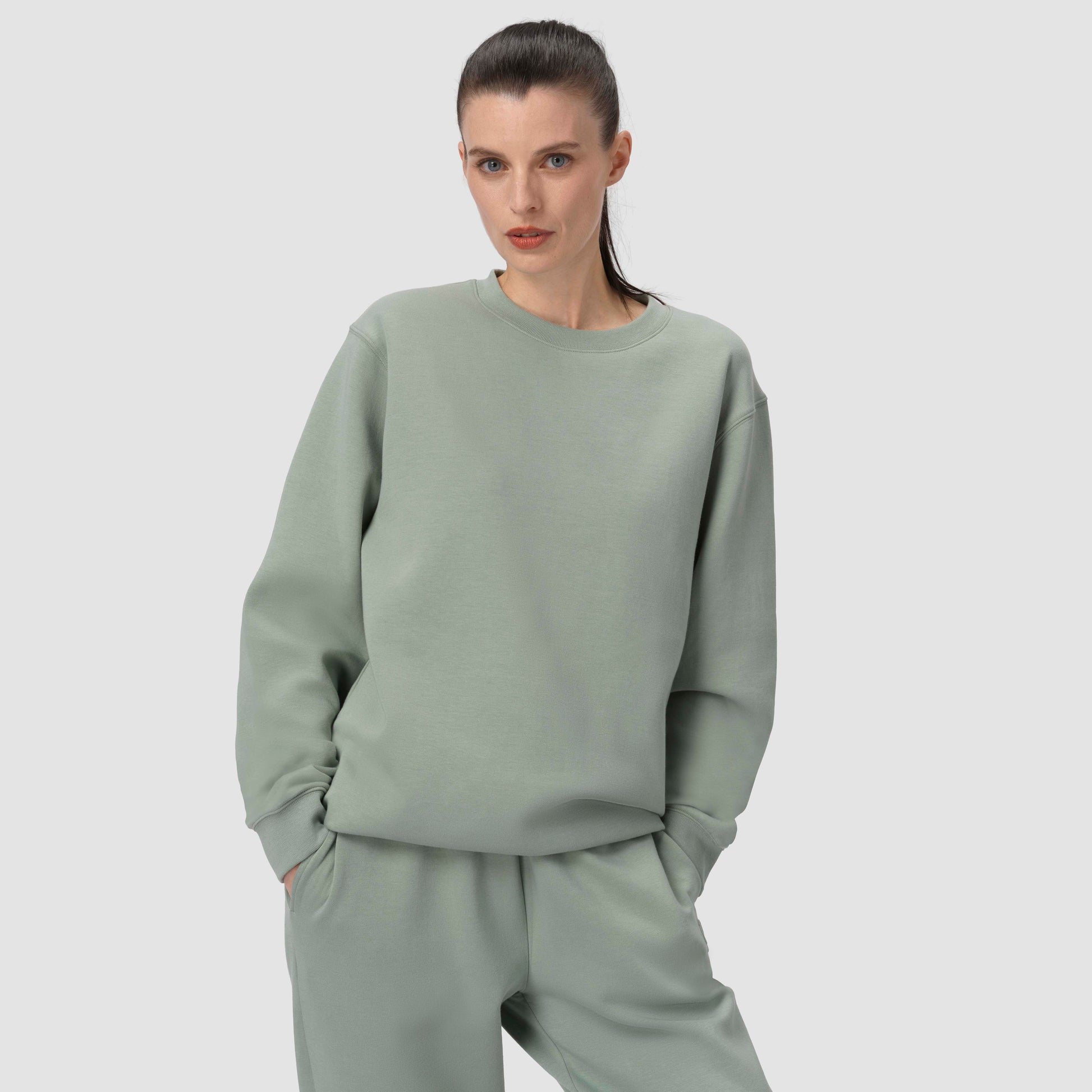 Model with green loungewear set with crewneck hoodie