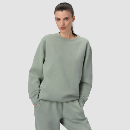 Model with green loungewear set with crewneck hoodie