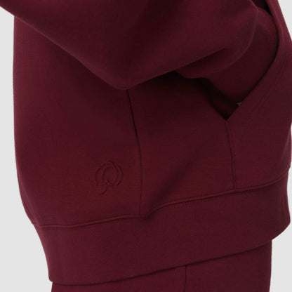 Burgundy hoodie with a logo against a white background