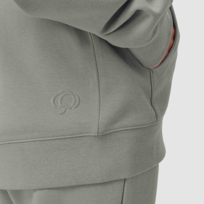 Sage green hoodie with a logo against a white background