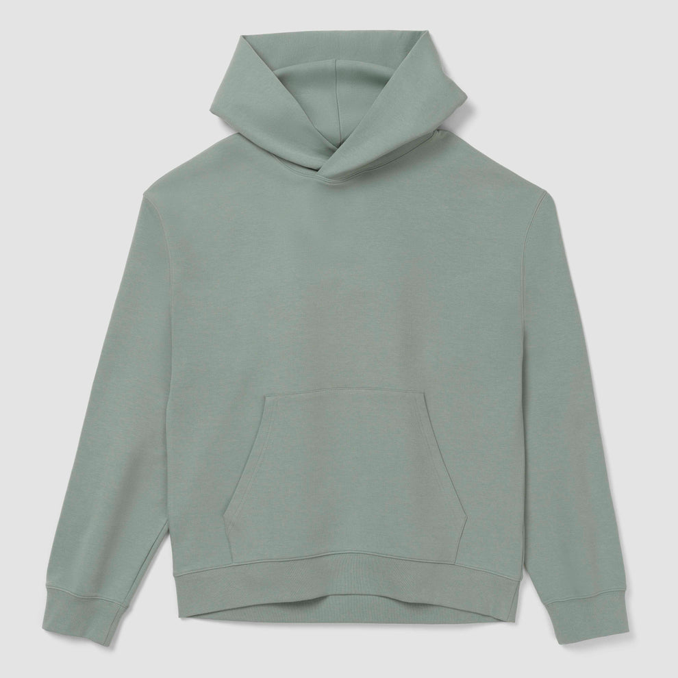 Sweat à capuche vert sur fond gris clair