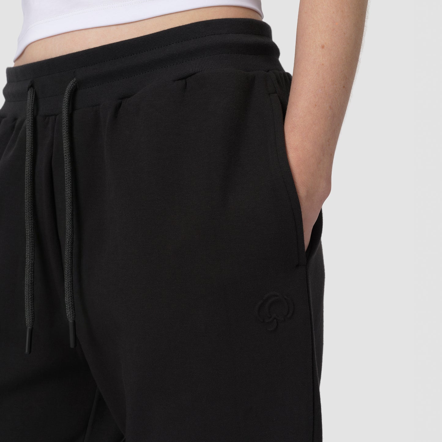 Black pants with drawstring waist on a white background