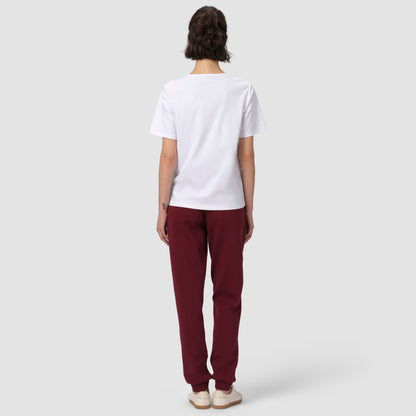 Back of model wearing burgundy jogger with white tee and shoes