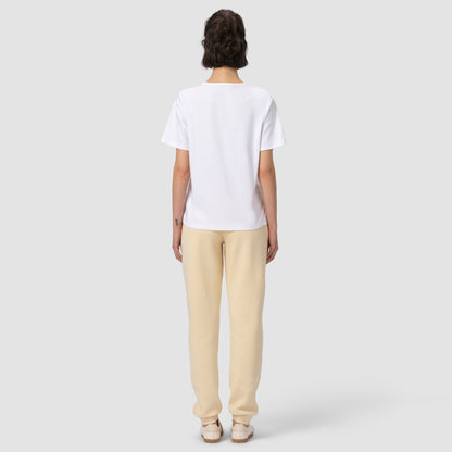 Back of model wearing cream jogger with white tee and shoes 
