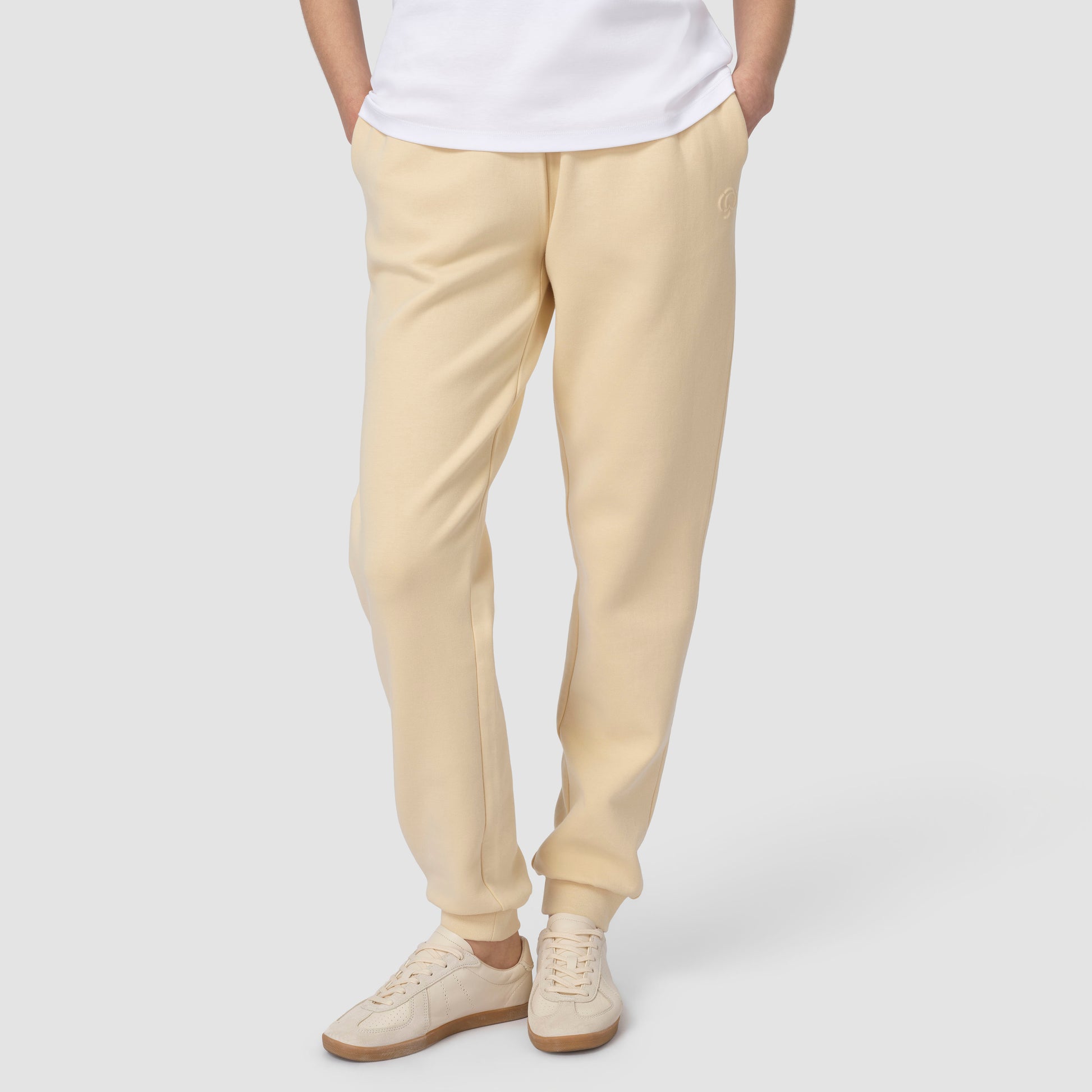 Bottom pic of person wearing cream jogging with white shoes