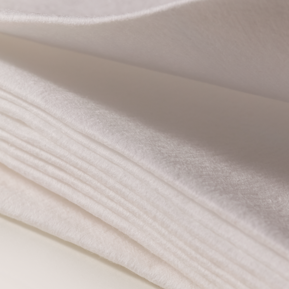 Close-up of white cotton towel fabric with subtle texture