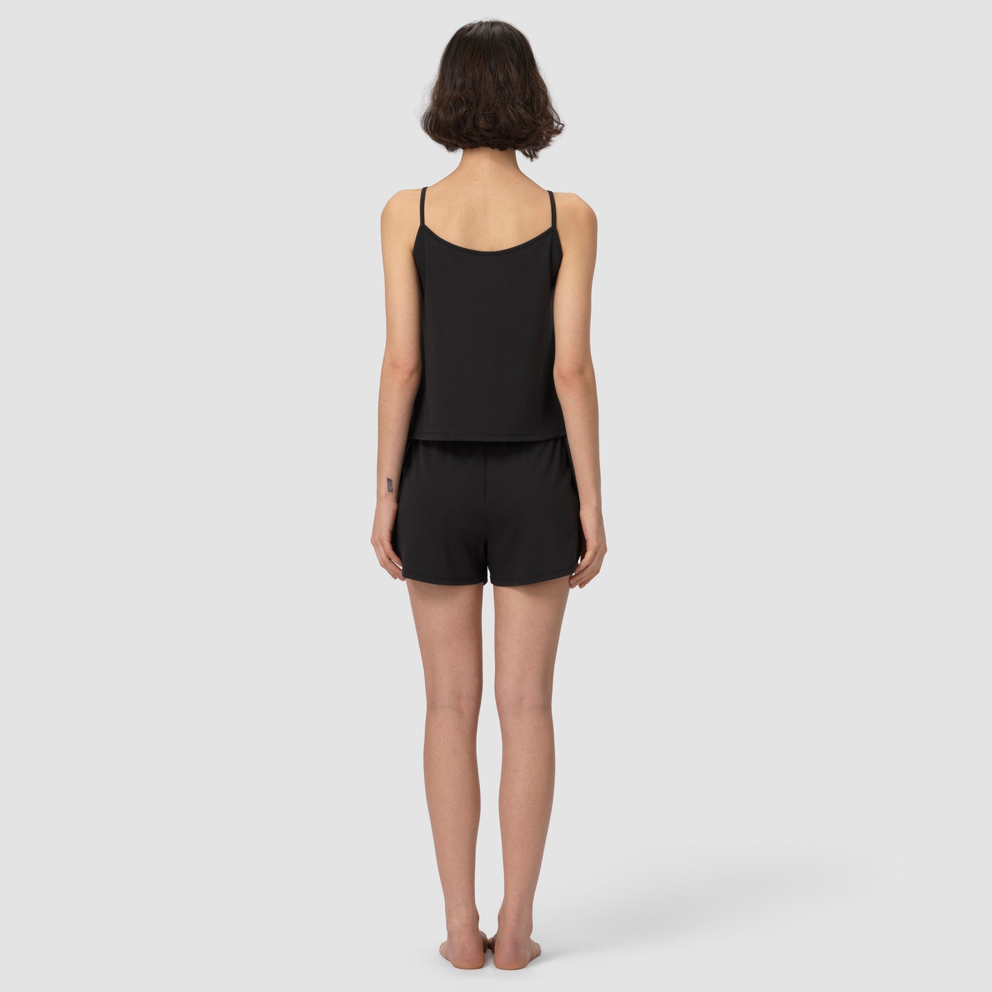 Back of a model wearing black pajama set