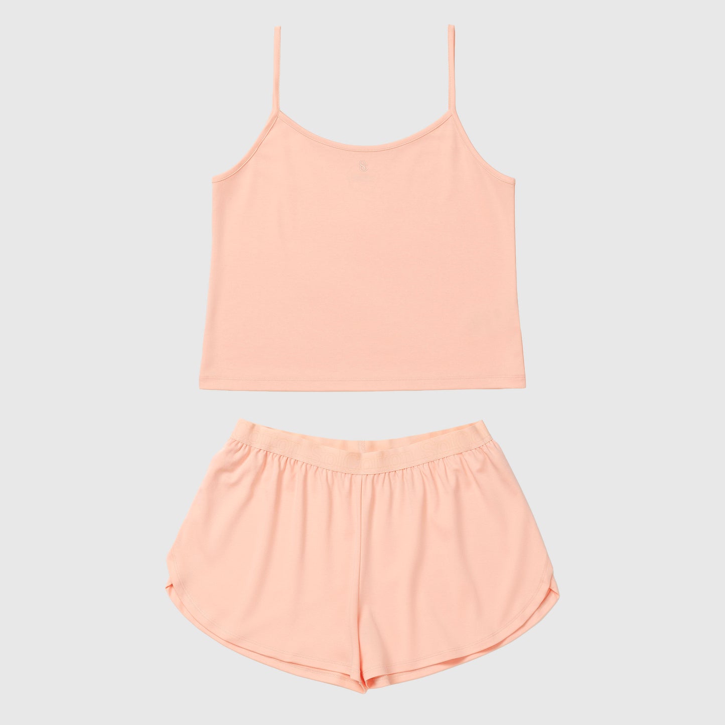 Salmon camisole and shorts set on a light gray background