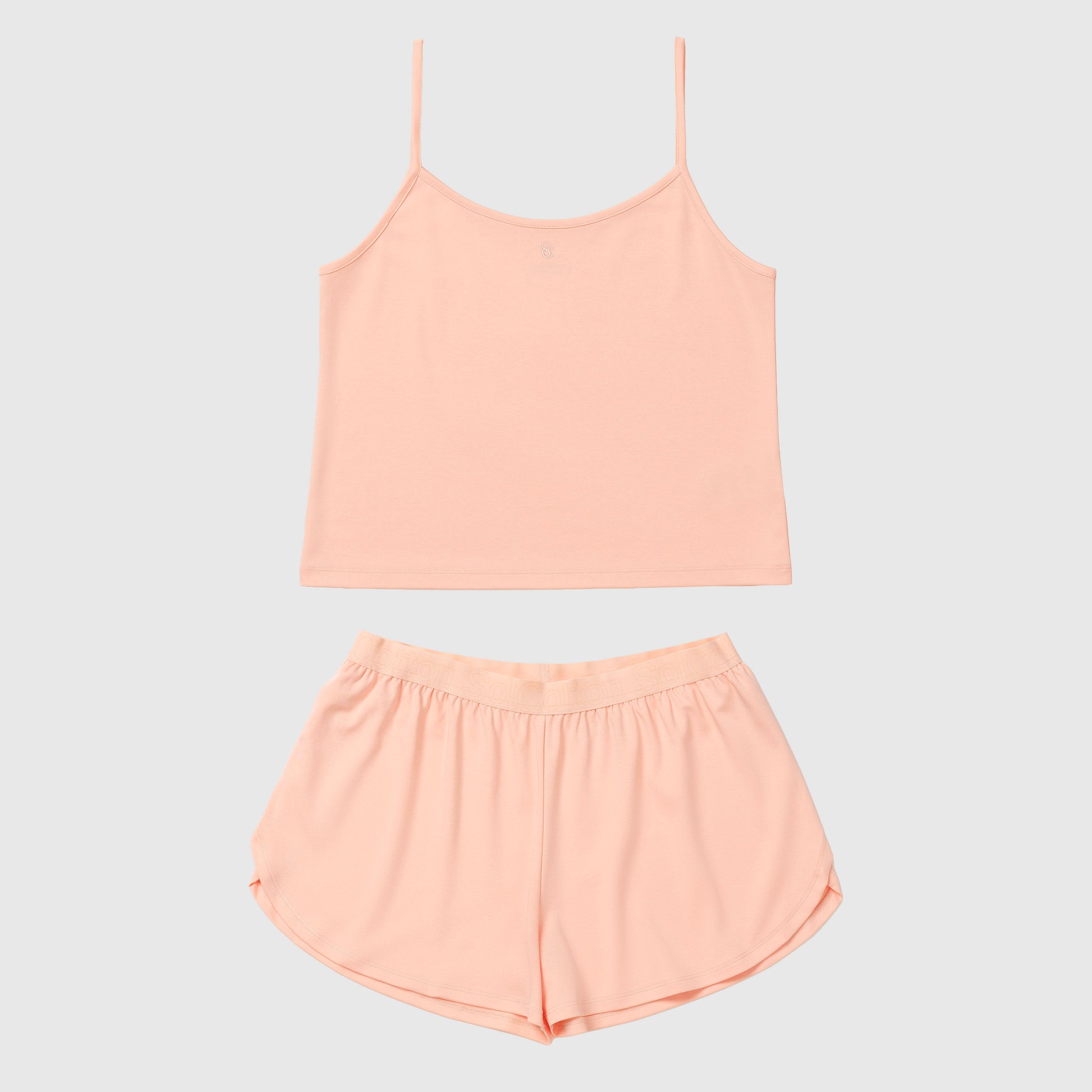 Salmon camisole and shorts set on a light gray background