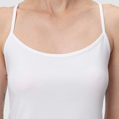 White tank top worn by a person on a light gray background