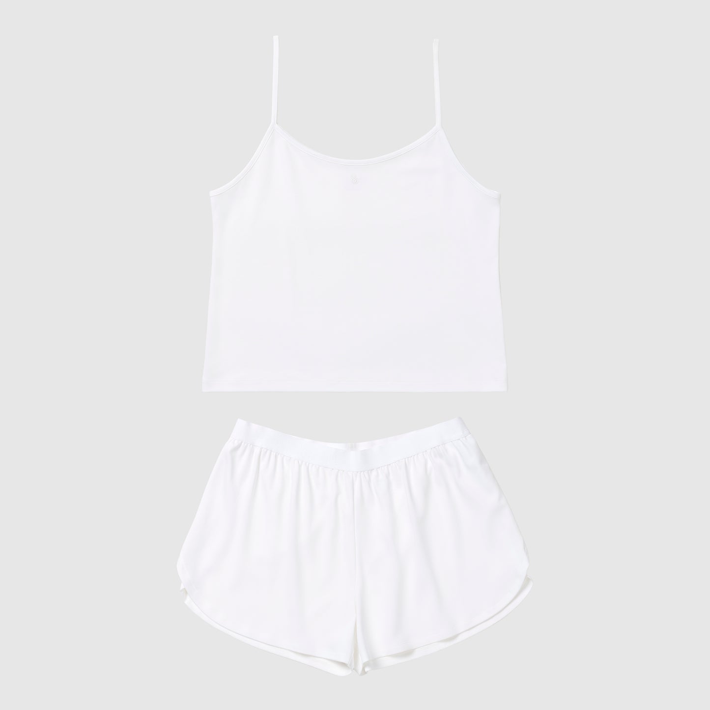 White tank top and shorts pajama set on a light gray background