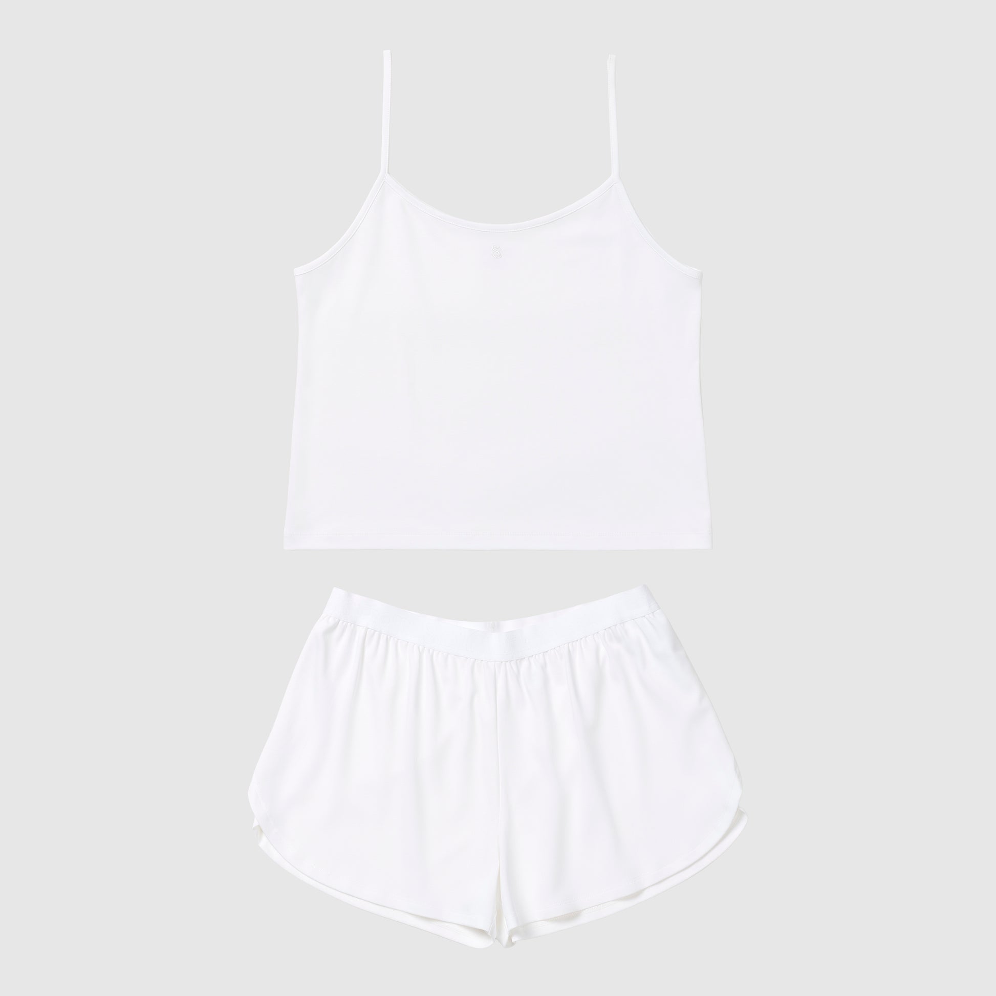 White tank top and shorts pajama set on a light gray background