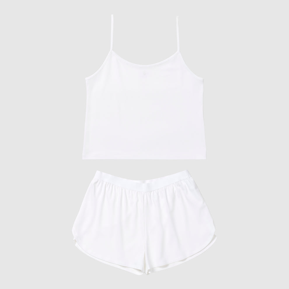 White tank top and shorts pajama set on a light gray background