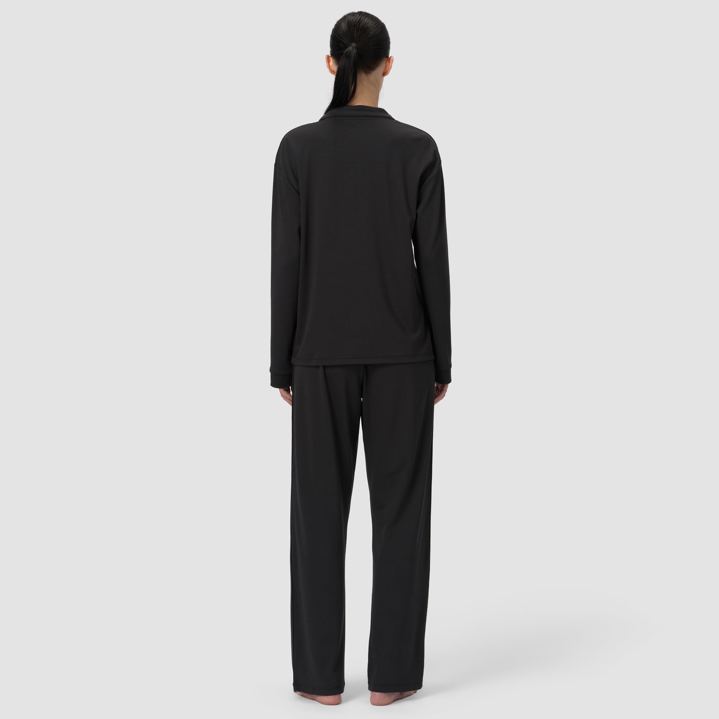 Back shot of black pajama Ava Classic worn by model