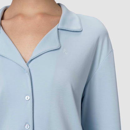 Light blue pajama with collar and buttons on a plain background