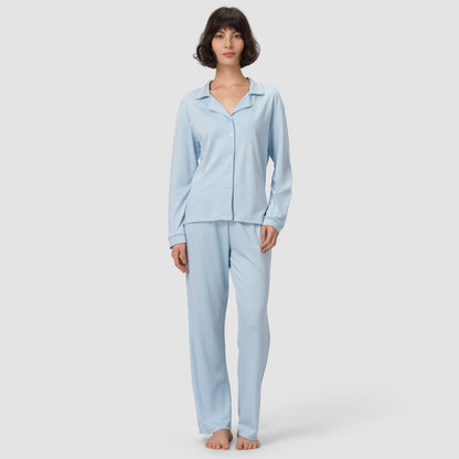 Woman wearing light blue pajamas on a white background
