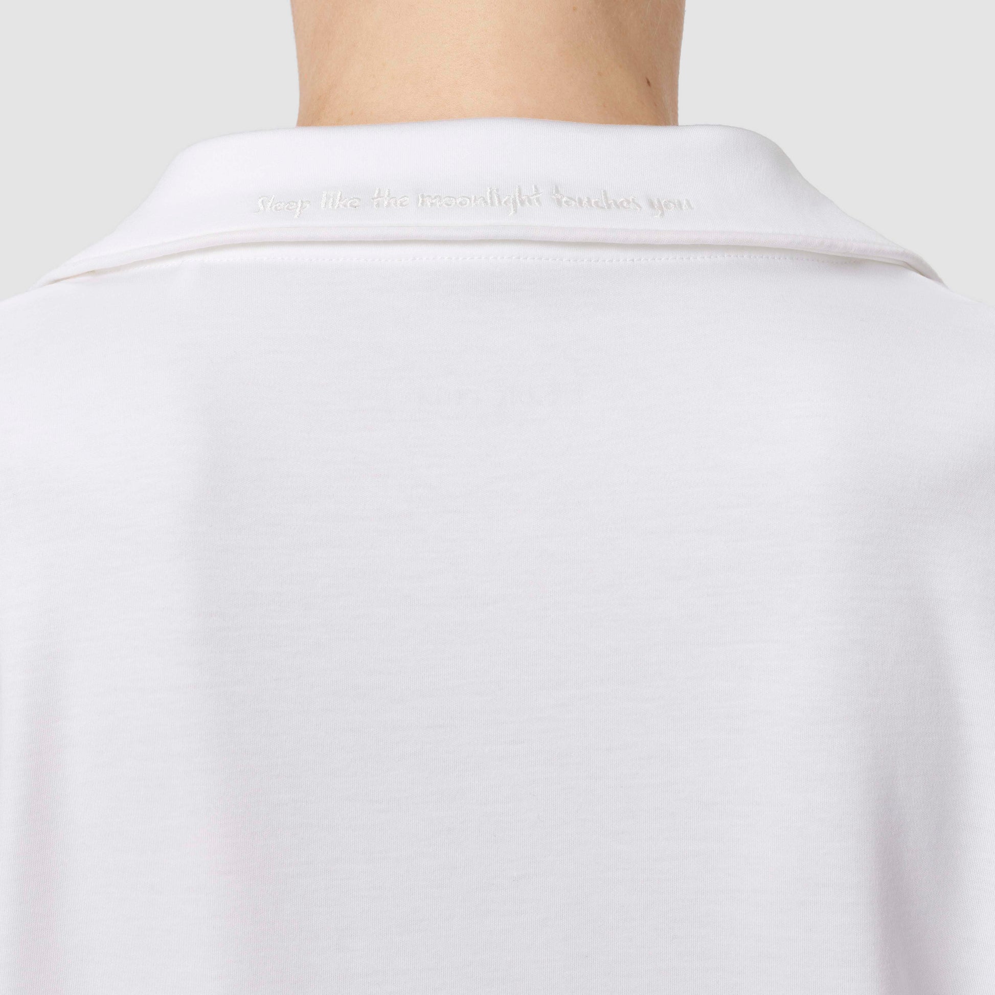 Close up of the back of white pajama top 