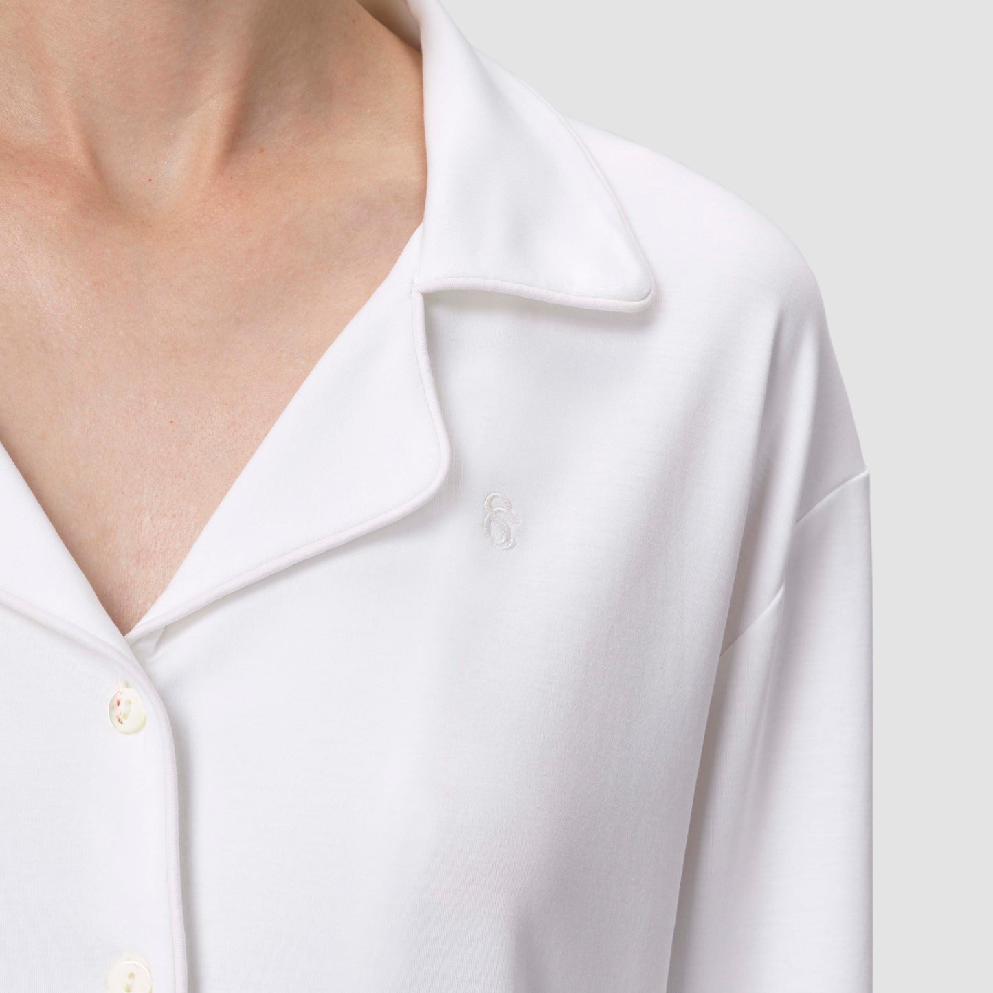 Close up shot of white pajama white top on plain background