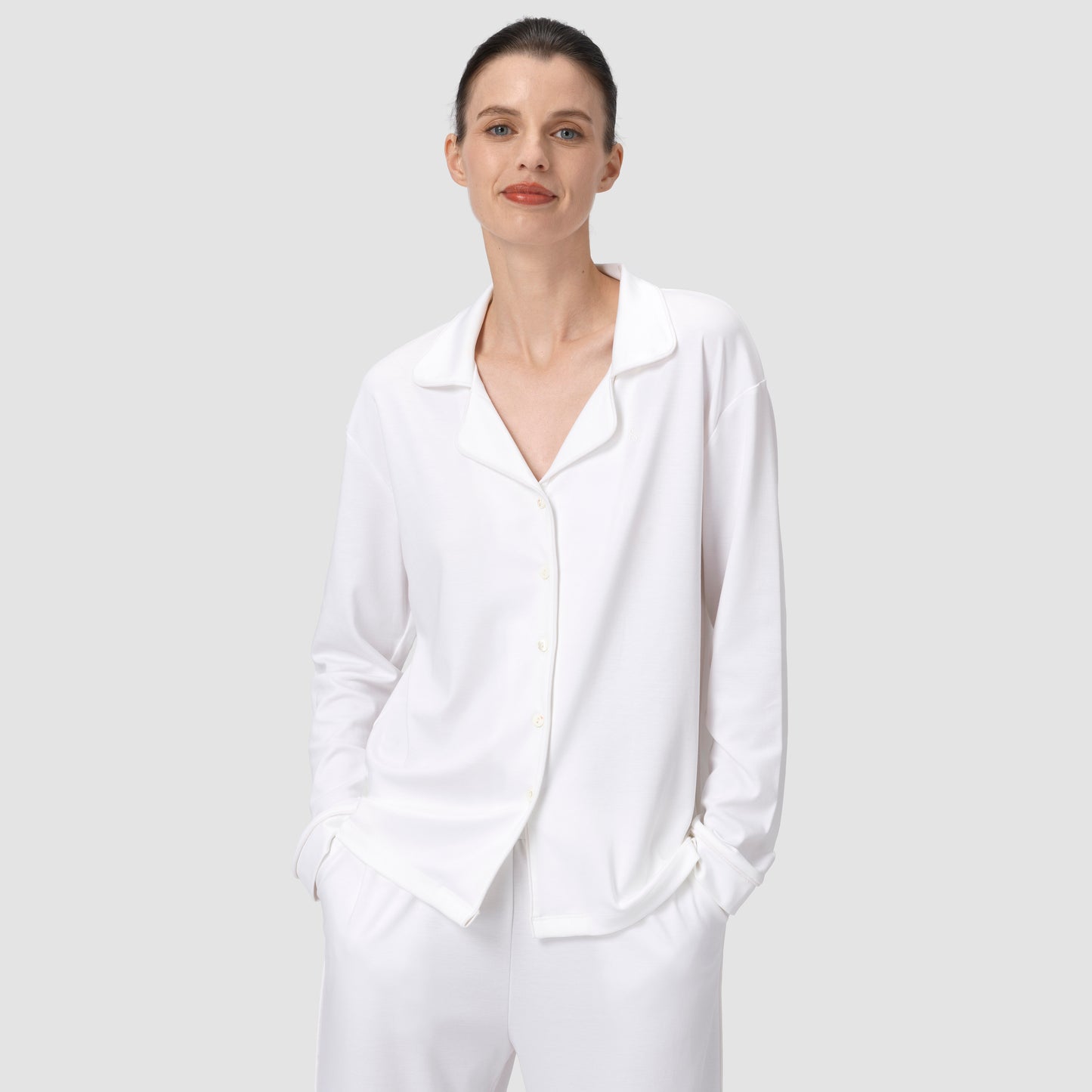 Ava Classic pajama set in white with model smiling on a plain background