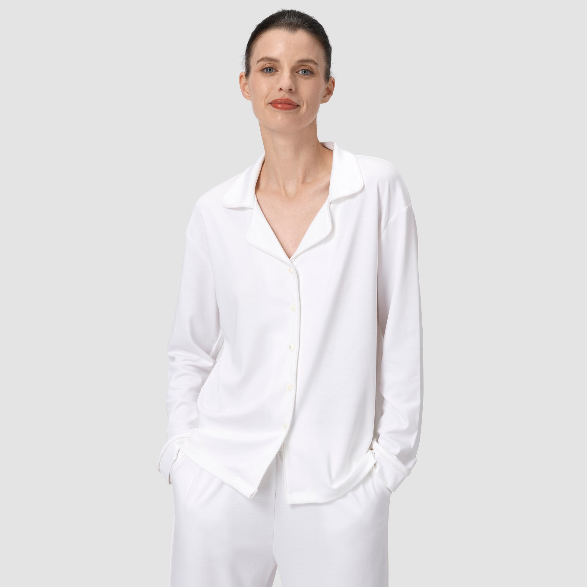 Ava Classic pajama set in white with model smiling on a plain background