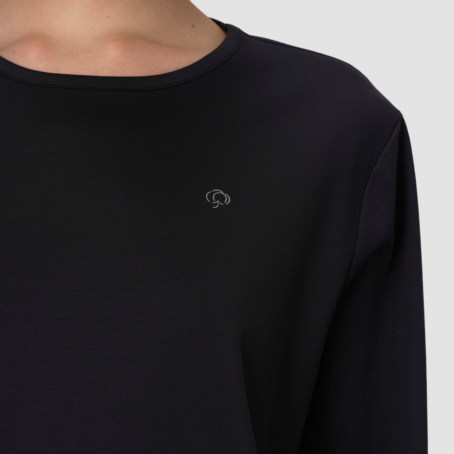 Close up of long sleeve black pajama with silver logo