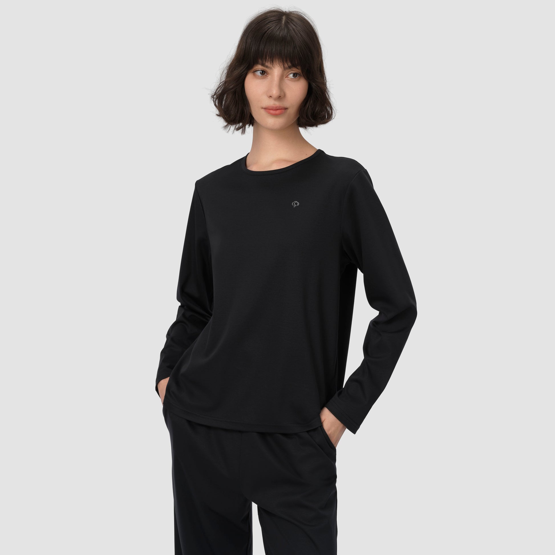 Model with a light smile wearing long pajama set