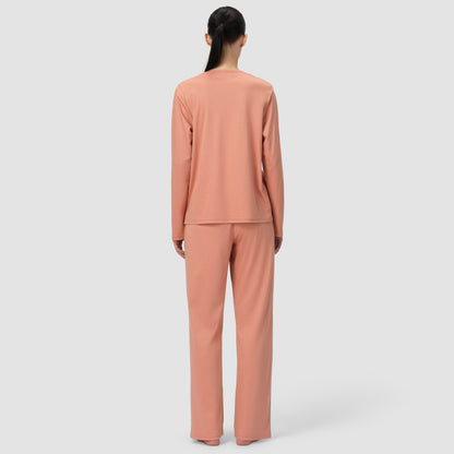 Back of model wearing long pajama set in terracotta color