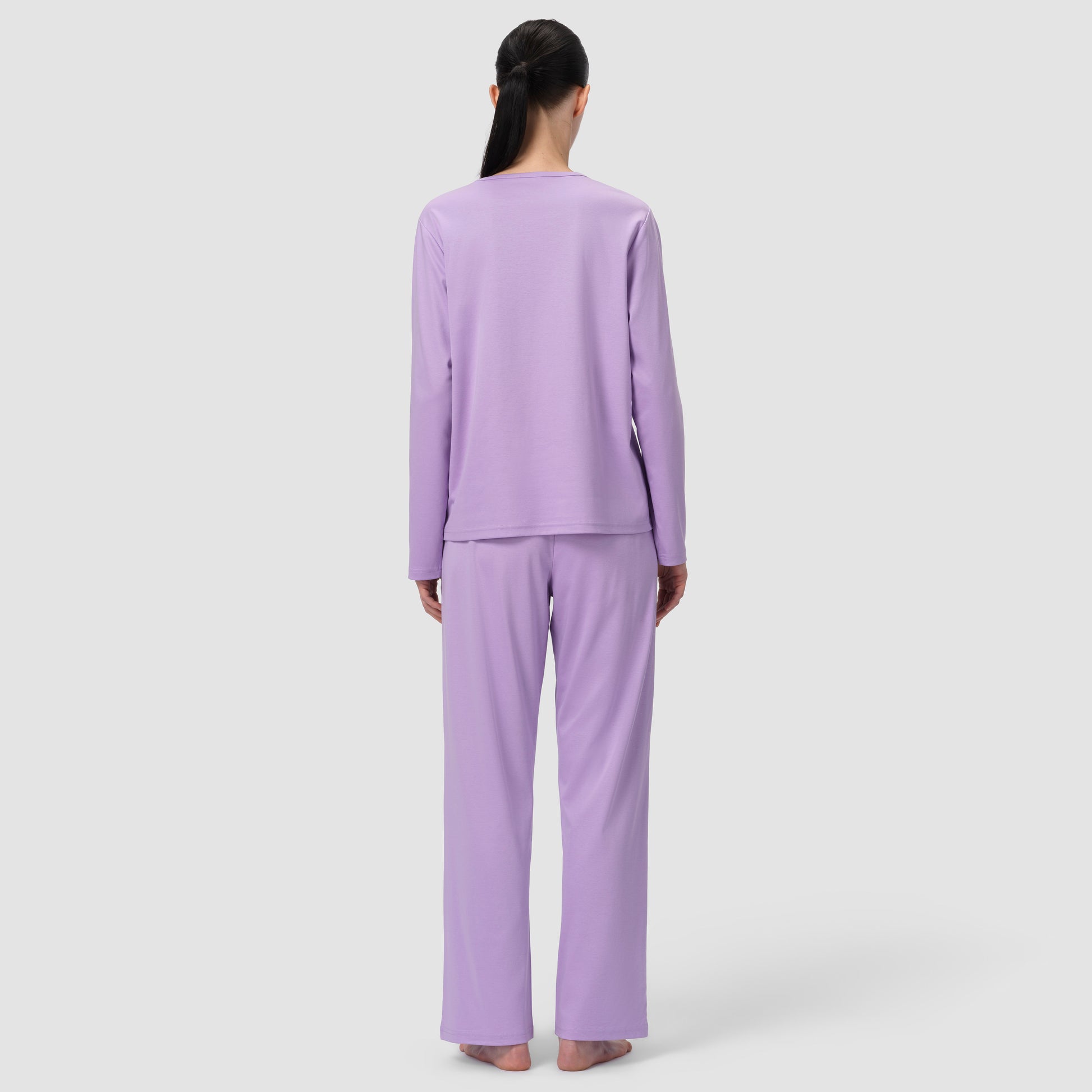 Back of model wearing long pajama et in lavender color