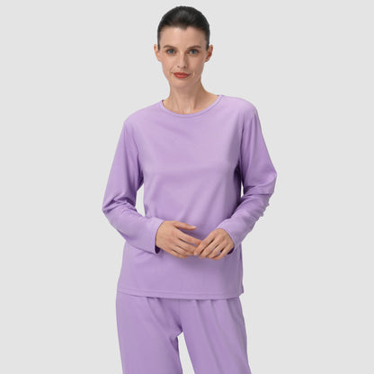 Model holding her hands wearing long lavender pajama set 