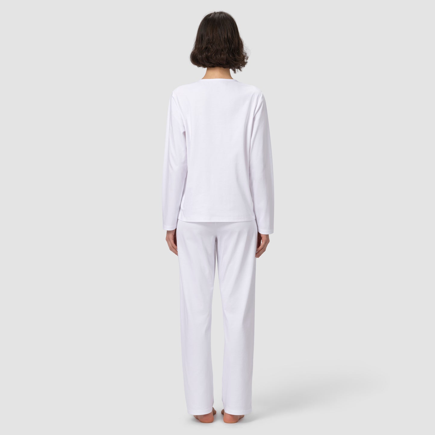 Back of model wearing long white pajama set