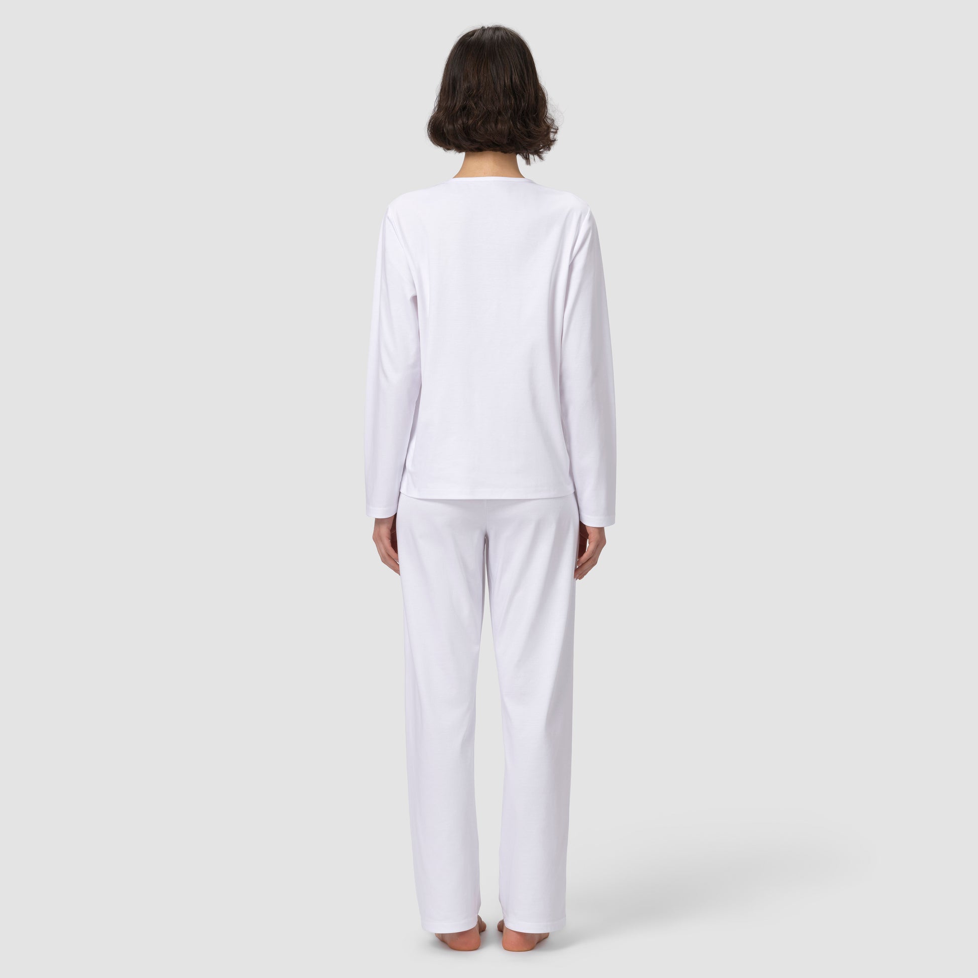 Back of model wearing long white pajama set