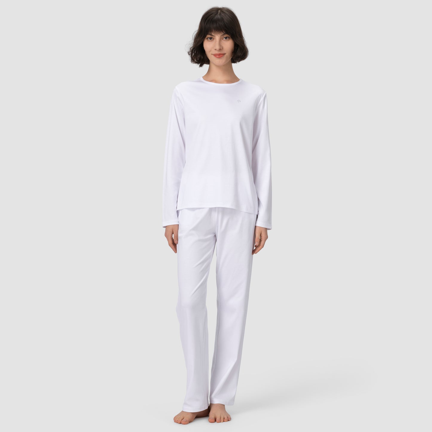 Full feet model wearing long white pajama set 