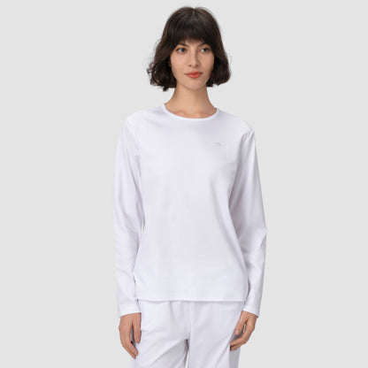 Model wearing long white pajama set in light grey background