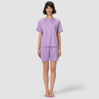 Full feet shot of model wearing lavender pajama set on grey background