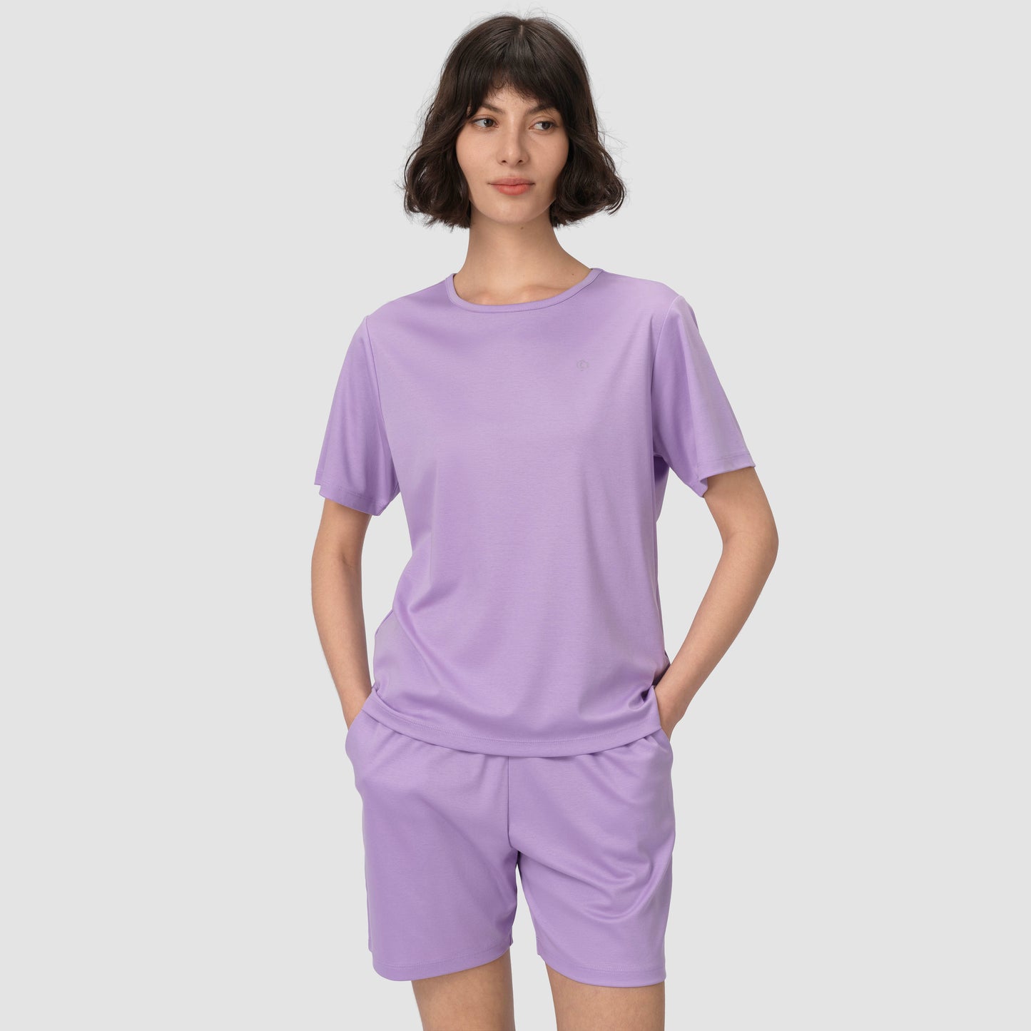 Model wearing lavender pajama set on a plain background