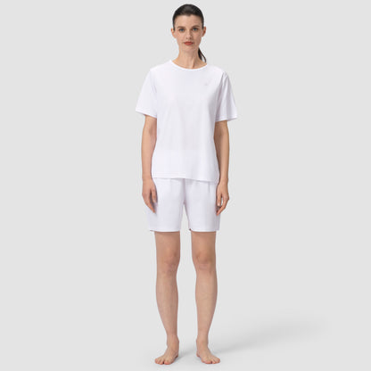 Full feet pic of model wearing white pajama matching set