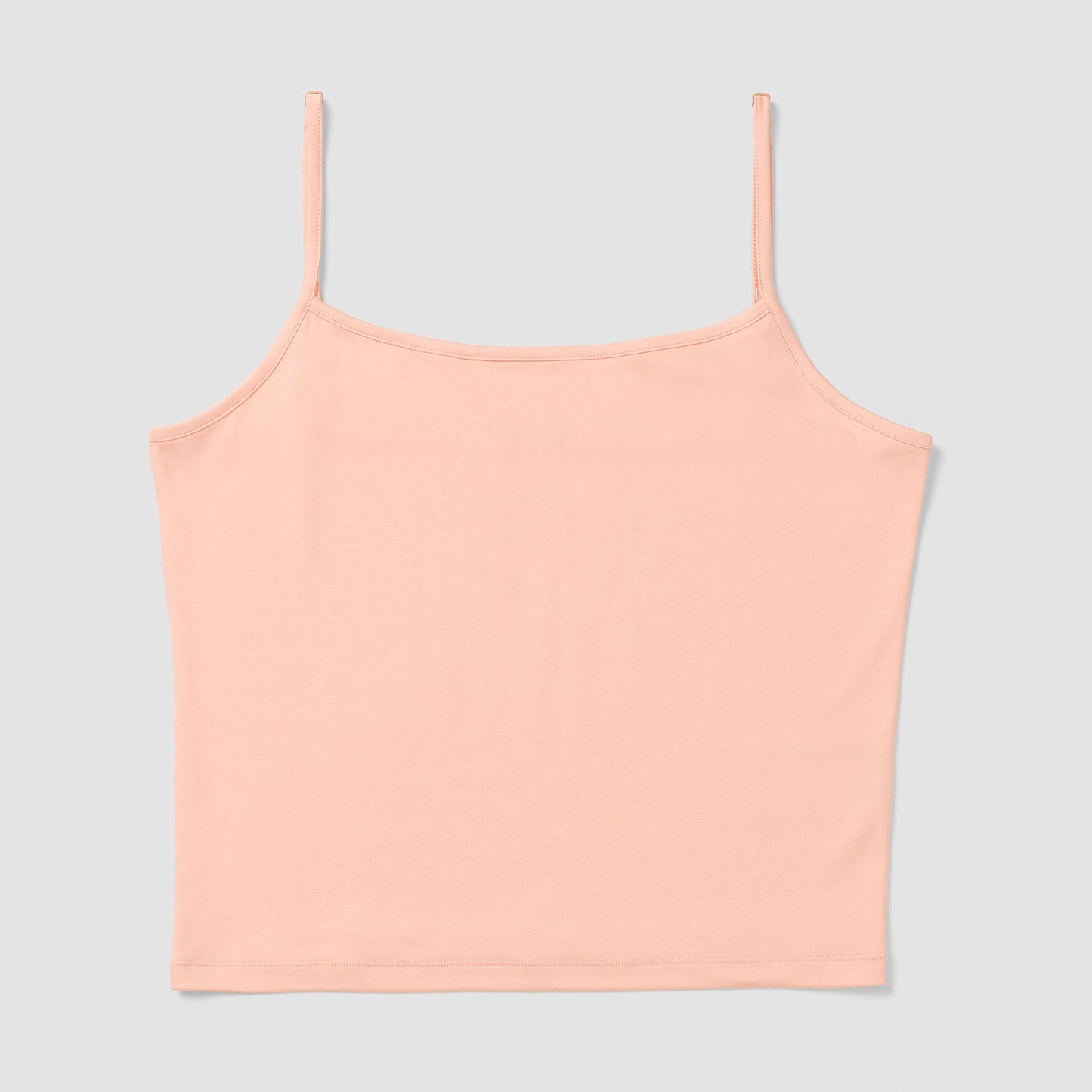 Salmon camisole top on a light gray background