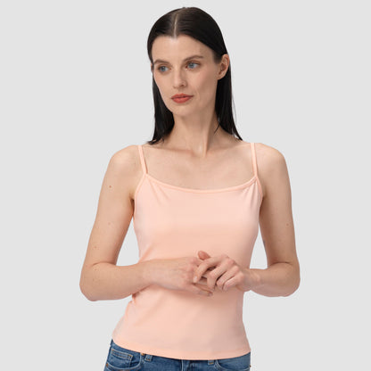 Woman wearing a light pink tank top against a plain background