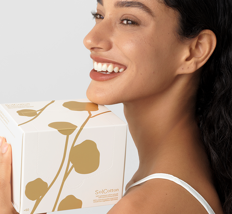 Femme tenant une boîte SolCotton avec un motif floral de La Divine