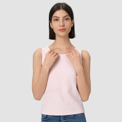 Woman wearing a light pink tank top against a plain background