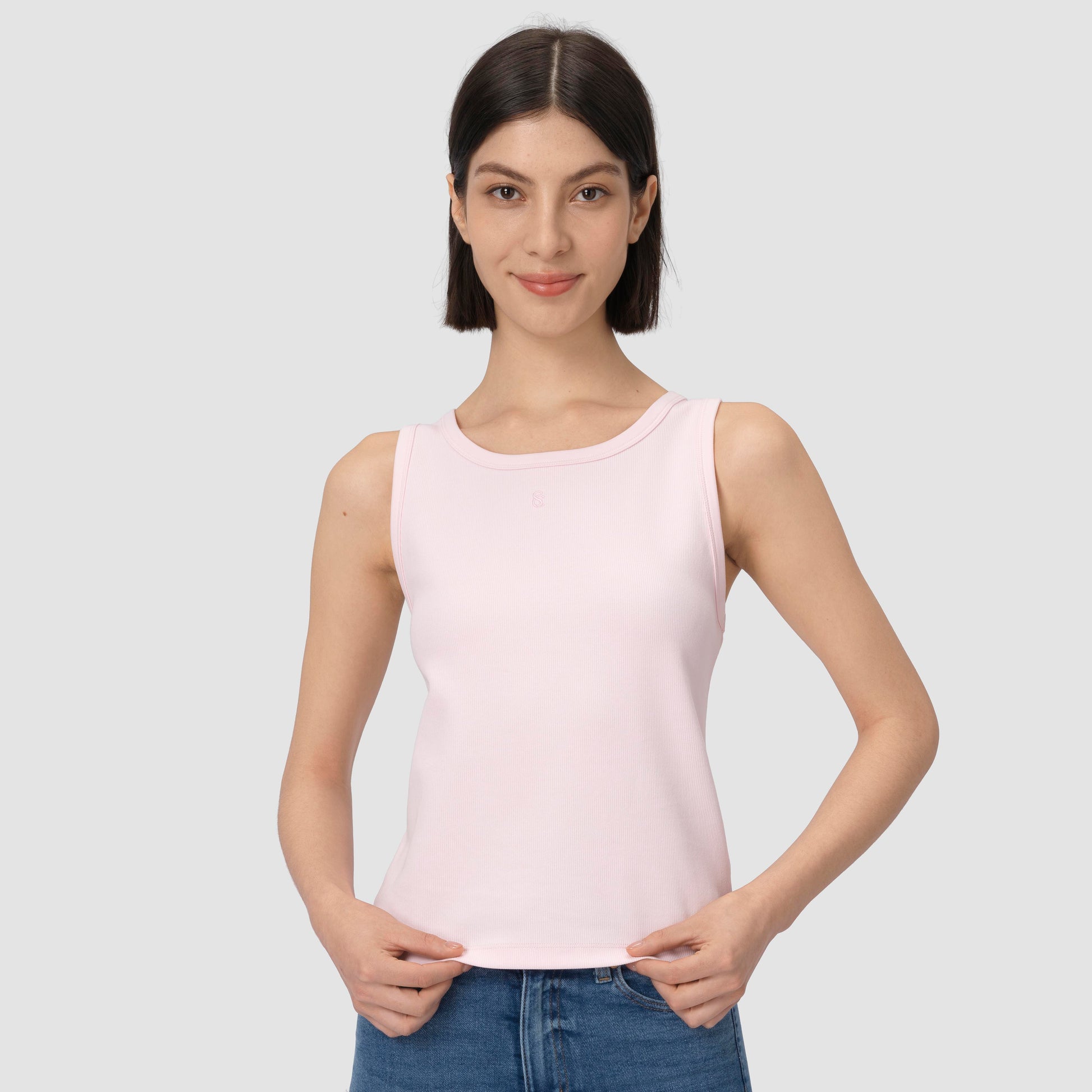 Woman wearing light pink tank top a bit closer