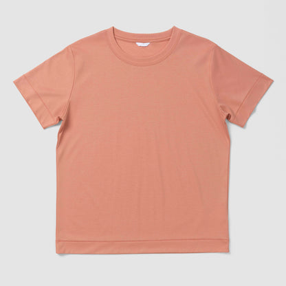 Plain orangy pink t-shirt on a light gray background